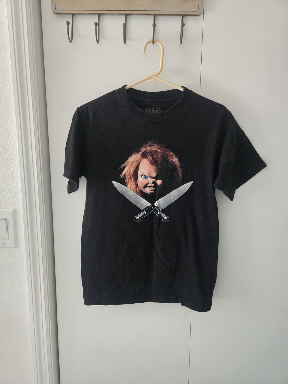Black Short-Sleeve Graphic Tee featuring Horror Doll and Crossed Knives